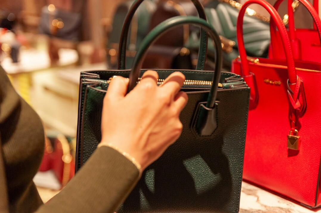 person hiding item in bag in store